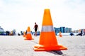 Orange cones on a city street. Limit traffic on a stretch of road. Unrecognizable faces. Genre photo