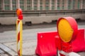 Orange construction light on barricade and red safety barriers on the road Royalty Free Stock Photo