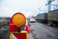 Orange construction light on barricade and red safety barriers on the road Royalty Free Stock Photo