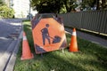 Orange Construction Sign with Stylized Man Digging