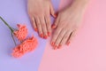 Orange coral nails and lisianthus Royalty Free Stock Photo