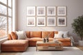 Orange corner sofa in the living room, coffee table and gallery wall art on the white wall. Large windows and daylight. Modern Royalty Free Stock Photo