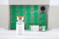 Orange cover injection vial on green vials background