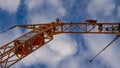 Orange crane on the blue sky clouds background Royalty Free Stock Photo