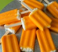 Orange creamsicle popsicles on a galvanized steel platter. Royalty Free Stock Photo