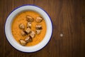 Orange creamy soup with croutons