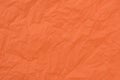 Orange creased tissue paper texture background Royalty Free Stock Photo