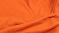 Orange crinkled cotton fabric. background or textura