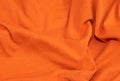 Orange crinkled cotton fabric. background or textura