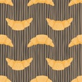 Orange croissants ornament seamless food pattern. Breakfast dessert silhouettes on brown stripped background