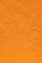 Orange crumpled wrinkled textured paper background