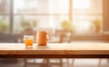 Orange cup of orange juice on wooden table in blurred background Royalty Free Stock Photo