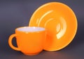 Orange cup and saucer Royalty Free Stock Photo
