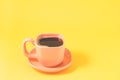 orange cup on a yellow background/orange cup of espresso with a skin on a yellow background Royalty Free Stock Photo