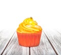 Orange cupcake with yellow cream Royalty Free Stock Photo