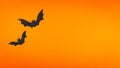 Orange cute Halloween background design with bats silhouettes and copy space