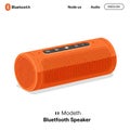 Orange cylindrical Bluetooth speaker with integrated control panel featuring play, pause, Royalty Free Stock Photo