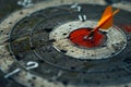 Orange dart hitting the center of an old target Royalty Free Stock Photo