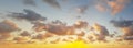 Orange dawn sky. Dramatic sunrise with dark cloud, gold sun and blue sky. Panoramic nature background Royalty Free Stock Photo
