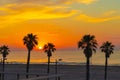 Orange dawn sunrise or sunset on the beach with palm trees Royalty Free Stock Photo