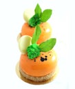 Orange desserts with green leaves and white chocolate