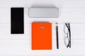 Orange diary with a pen, stylish glasses and a case for glasses Royalty Free Stock Photo