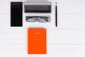 Orange diary with a pen, stylish glasses and open case for glass Royalty Free Stock Photo