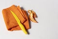 Orange dishcloth with yellow knife and pepper