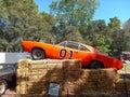 orange 1969 Dodge Charger General Lee from the Dukes of Hazzard over hay bales. Classic muscle car Royalty Free Stock Photo