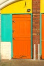 Orange door to business premises & security locks