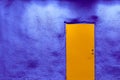 Orange door and ultramarine blue wall.