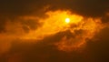 Orange dramatic cloudy sky and bright sun nature background