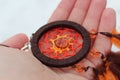 Orange dreamcatcher with a stone in hand. Royalty Free Stock Photo