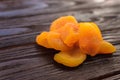 Orange dried apricot on a dark wooden table textural Royalty Free Stock Photo