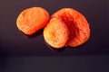 Orange dried apricots on a dark mirror background, close-up Royalty Free Stock Photo