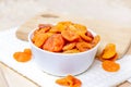 Orange dried apricots in white bowl on light background. Royalty Free Stock Photo