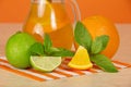 Orange drink, citrus, mint and striped napkin on a Royalty Free Stock Photo