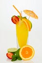 Orange drink in a highball glass with fresh fruits