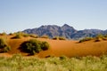 Typical landscape of Namibia, orange dunes with mountains in back, Namibia, Africa Royalty Free Stock Photo