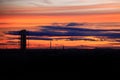 Orange dusk over silhouette of industrial district