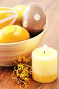 Orange easter eggs in a cup with american witchhazel twig and ca