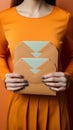 Orange elegance Female hand showcases paper envelopes in top view composition