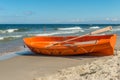 A orange emergency boat on beautiful beach Royalty Free Stock Photo