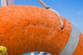 Orange emergency lifebuoy on a pebbly sea beach, close up Royalty Free Stock Photo