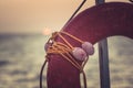 Orange emergency lifebuoy on a pebbly sea beach, close up Royalty Free Stock Photo