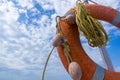 Orange emergency lifebuoy on a pebbly sea beach, close up Royalty Free Stock Photo