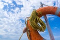 Orange emergency lifebuoy on a pebbly sea beach, close up Royalty Free Stock Photo