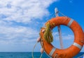 Orange emergency lifebuoy on a pebbly sea beach, close up Royalty Free Stock Photo