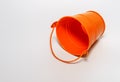 Orange empty pail, orange bucket on white background.