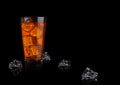 Orange energy soda drink glass with ice cubes